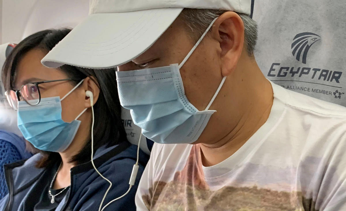 Passengers wear protective masks, following the outbreak of the coronavirus disease. (AFP Photo)