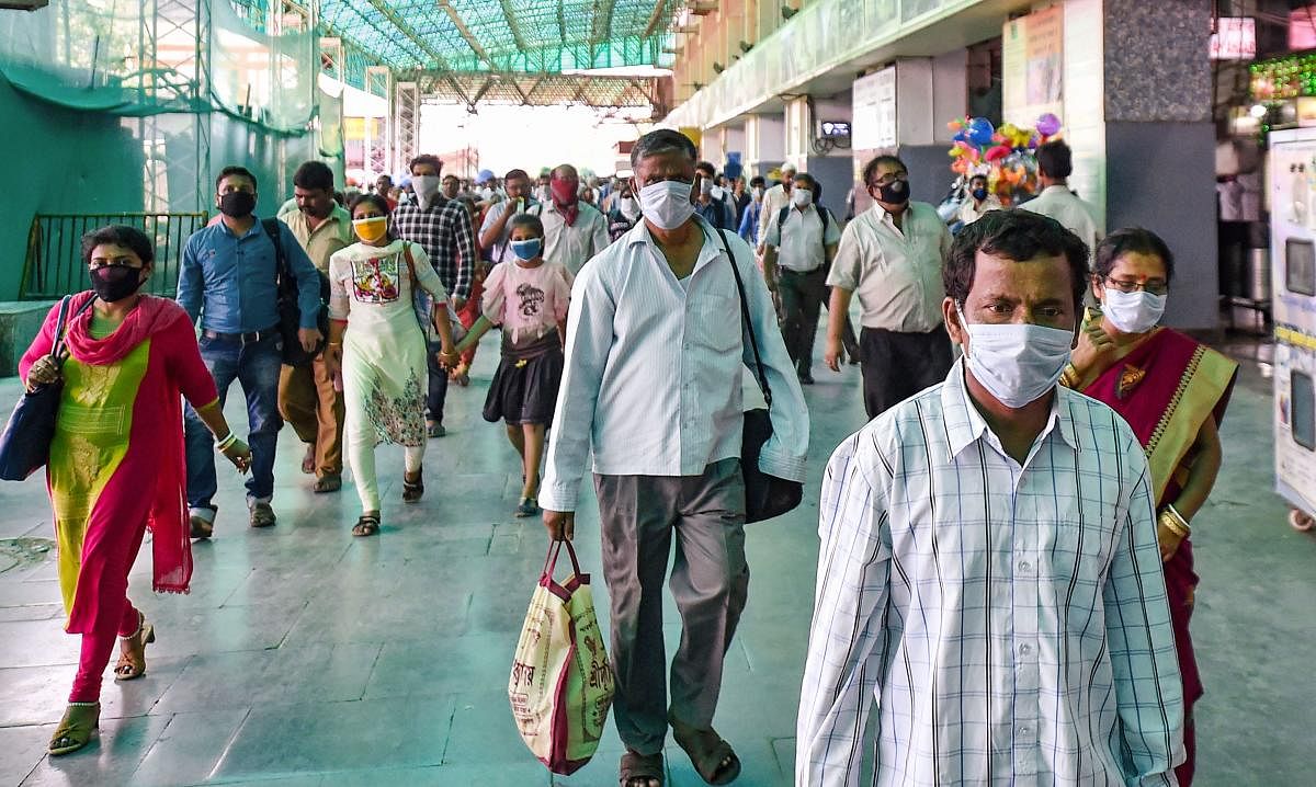 Passengers wearing masks in the wake of coronavirus pandemic, at Sealdah railway station in Kolkata, Saturday, March 21, 2020. (PTI Photo)