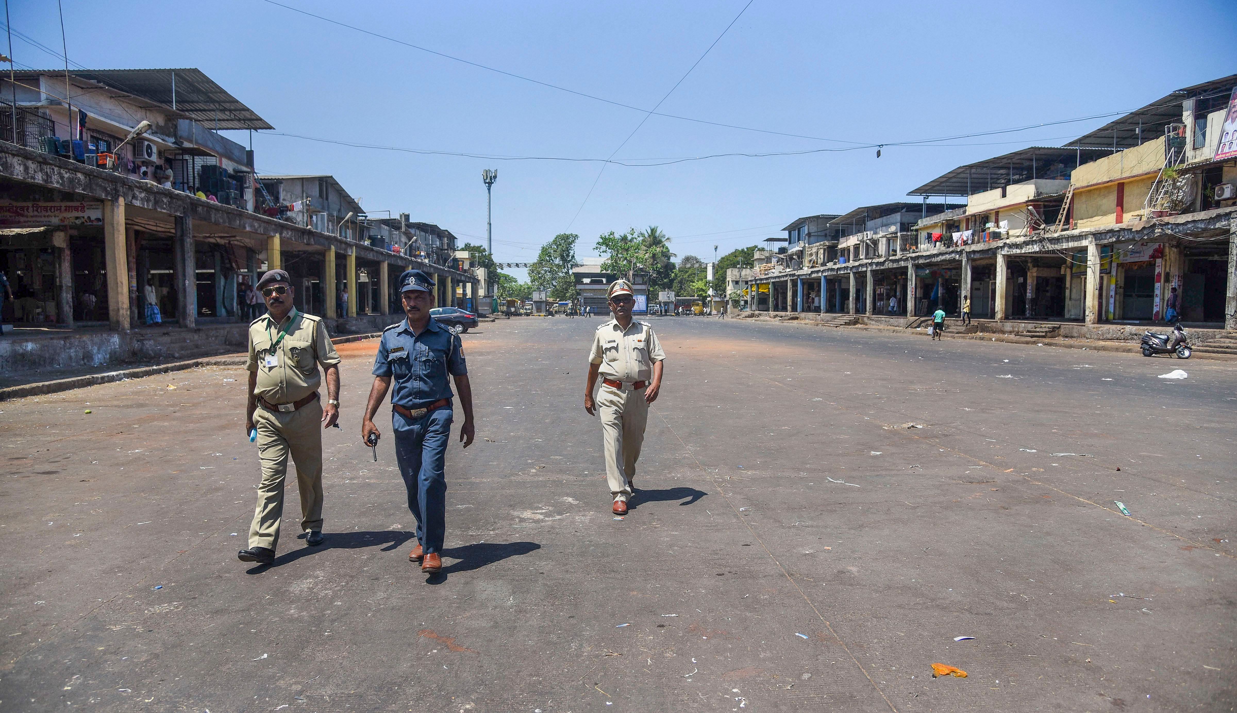 Police personnel patrol a deserted street of APMC market after it was closed in wake of coronavirus outbreak, in Navi Mumbai. (Credit: PTI)