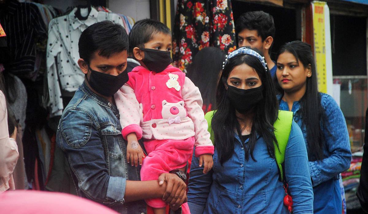 People wear masks as preventive measures in the wake of the novel coronavirus scare at Fancy Bazar market in Guwahati, ([PTI Photo)