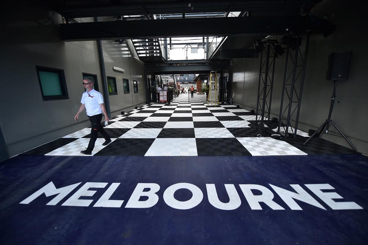A man walks down a hall at the Albert Park circuit ahead of the Formula One Australian Grand Prix in Melbourne on March 11, 2020. Credit: AFP Photo