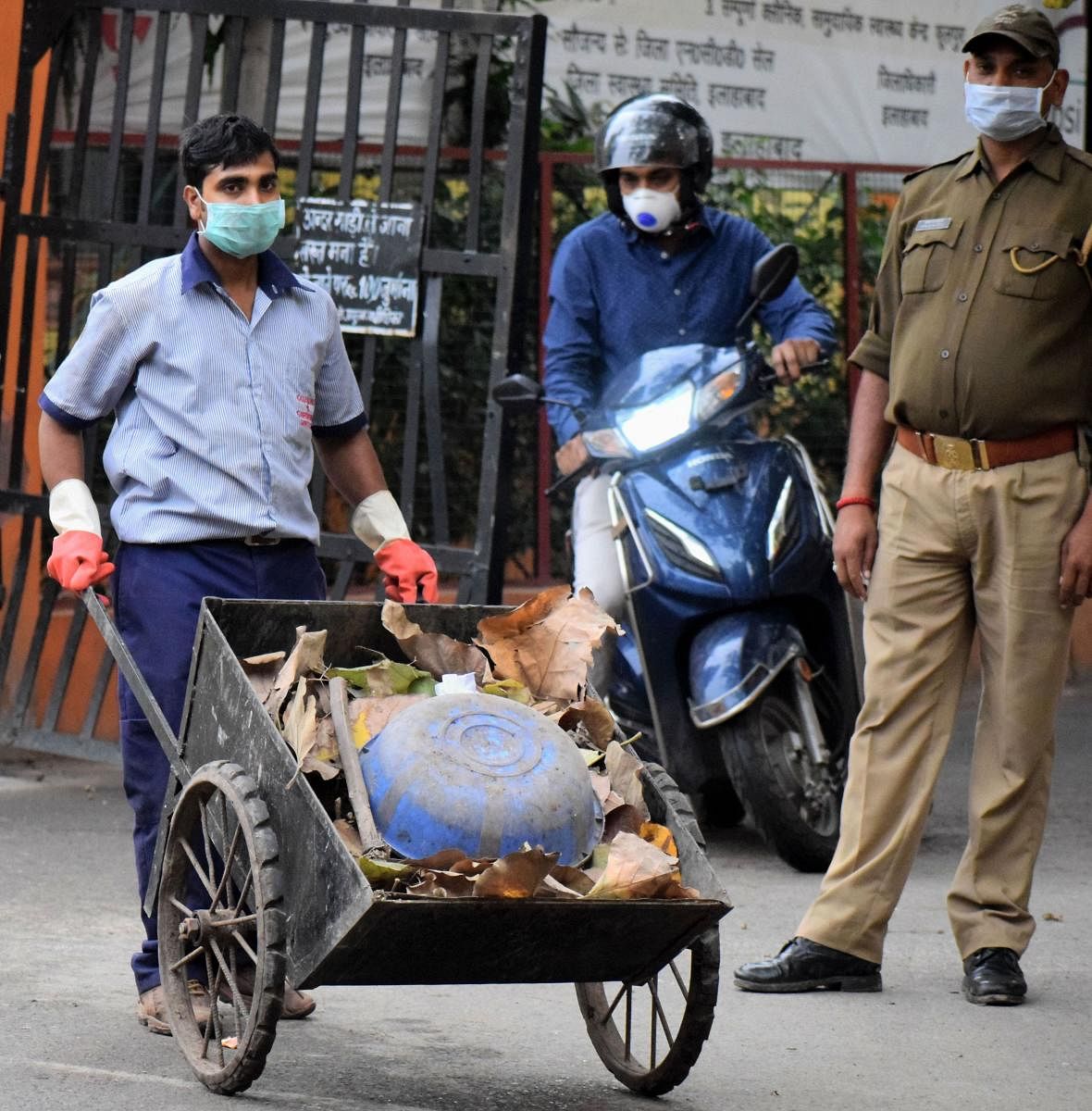A cleaning staff member takes out the garbage in the wake of deadly coronavirus (PTI Photo)