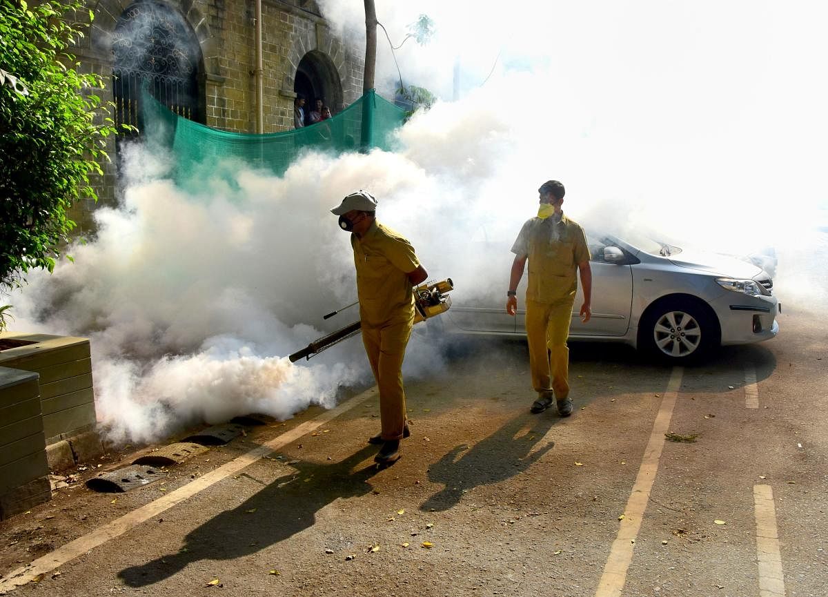 A BMC Municipal worker fumigates Ballard Estate in the wake of coronavirus pandemic, in Mumbai (PTI Photo)