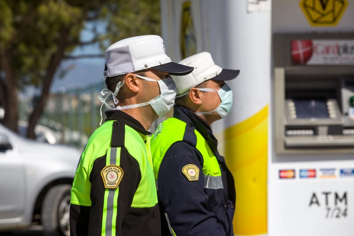 Police officers wearing protective masks stand guard at an entrance of the Salamis Bay Conti Hotel, under quarantine due to the novel coronavirus outbreak, in the eastern Cypriot port city of Famagusta in the self-proclaimed Turkish Republic of North Cyprus (TRNC), on March 10, 2020. Credit: AFP Photo