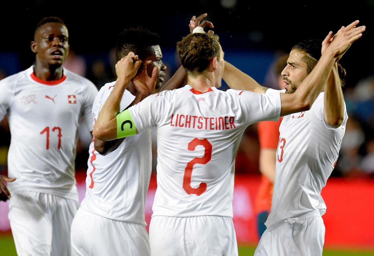 Switzerland's defender Ricardo Rodriguez (right) celebrates his goal with teammates during their game against Spain on Sunday. AFP