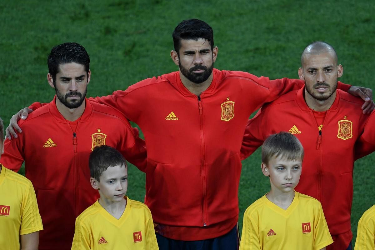 Spain's midfielder Isco, Spain's forward Diego Costa and Spain's forward David Silva listen to their national anthem before the Russia 2018 World Cup Group B football match between Spain and Morocco at the Kaliningrad Stadium in Kaliningrad on June 25, 20