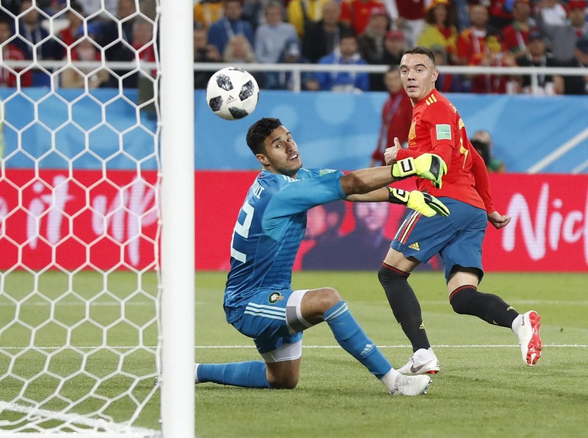 CLEVERLY DONE: Morocco goalkeeper Monir El Kajoui (left) watches in horror as Iago Aspas' back-heel flies into the net during the Group B clash against Spain on Monday. AP/PTI