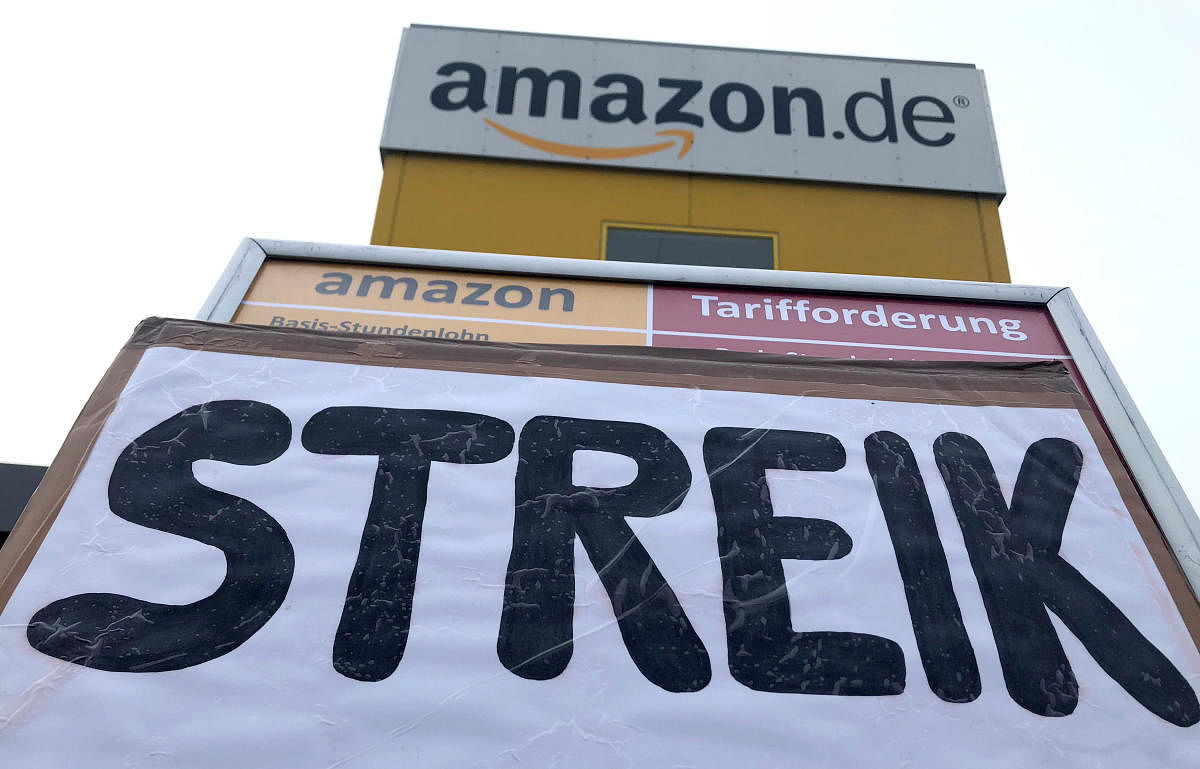 A placard calls on workers at an Amazon logistics center to go on strike in Bad Hersfeld, Germany, November 23, 2018, walking off the job on Black Friday, the discount spending spree that kicks-off the start of the crucial Christmas shopping season. Amazo