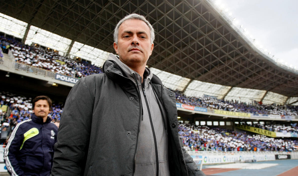 FILE PHOTO: Real Madrid's coach Jose Mourinho looks on as he enters the pitch before their Spanish first division soccer match against Real Sociedad at Anoeta stadium in San Sebastian, northern Spain, May 26, 2013. REUTERS/Joseba Etxaburu/File Photo