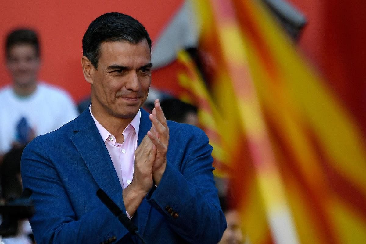 Spanish Prime Minister Pedro Sanchez applauds at the end of a campaign rally in Barcelona. (Photo by AFP)
