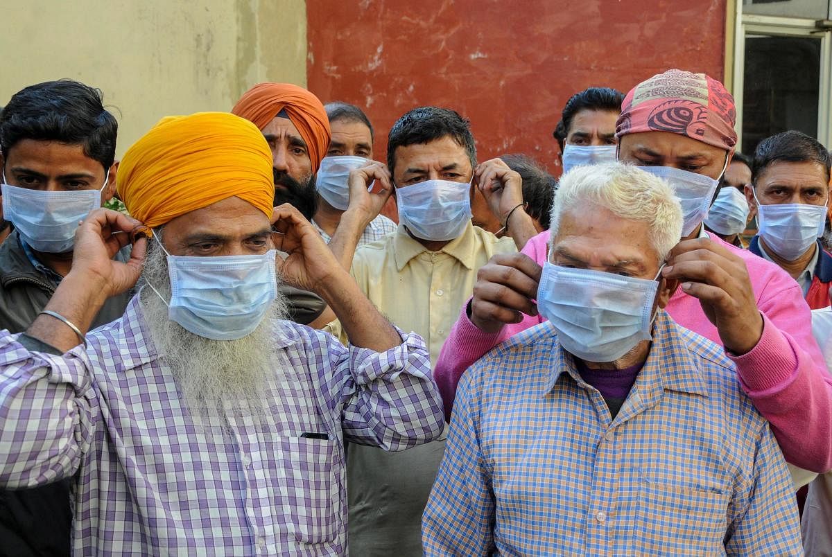 Factory workers wear masks in the wake of Covid-19 scare in Amritsar on Sunday. PTI
