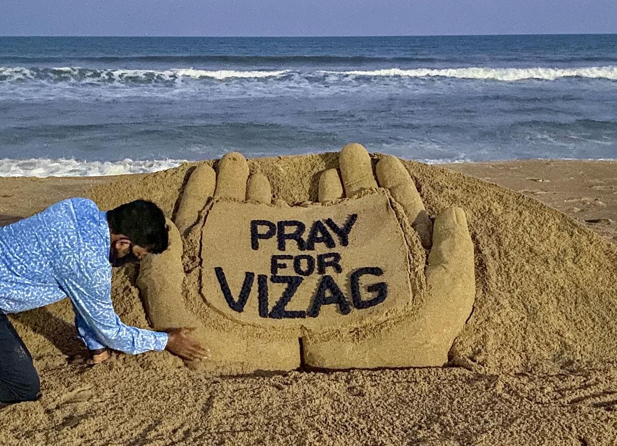 Renowned sand artist Sudarsan Pattanaik creates a sand sculpture on the Vizag gas leak, at Puri beach of Odisha, Thursday, May 7, 2020. (PTI Photo)