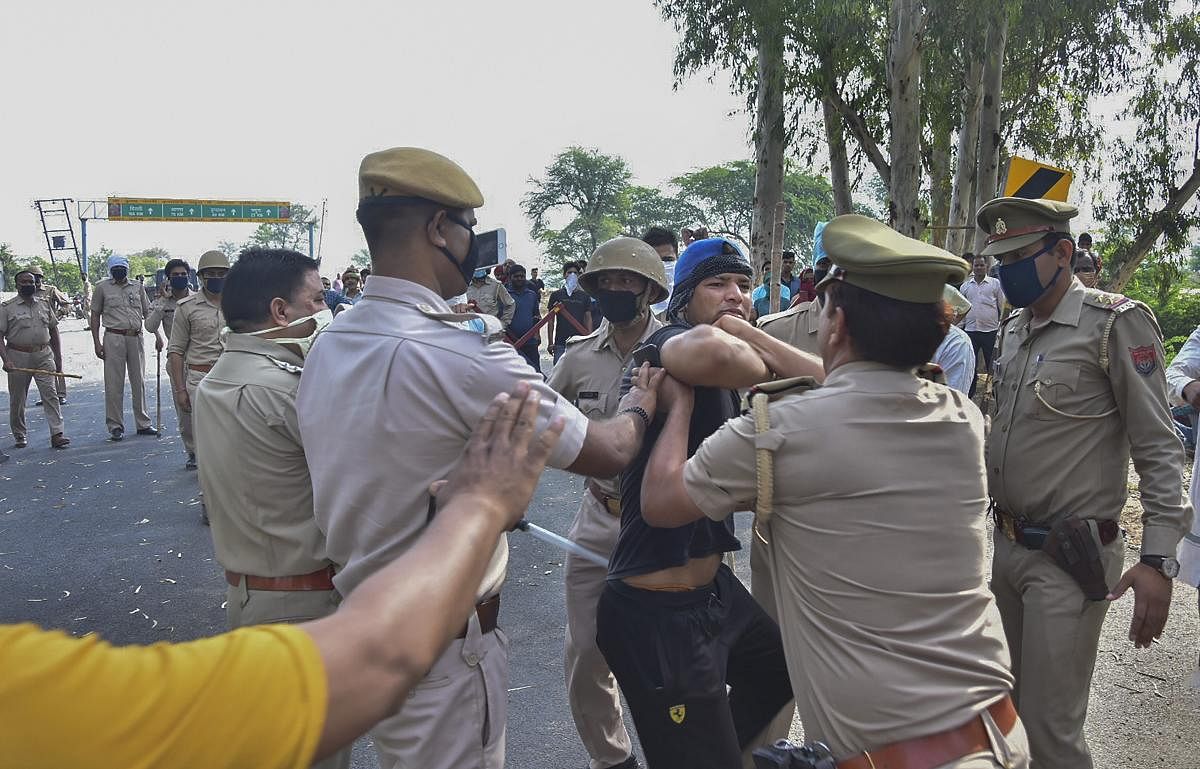 Police personnal attempt to stop migrants trying to cross Rajasthan-UP border, during the ongoing COVID-19 nationwide lockdown, in Mathura (PTI Photo)