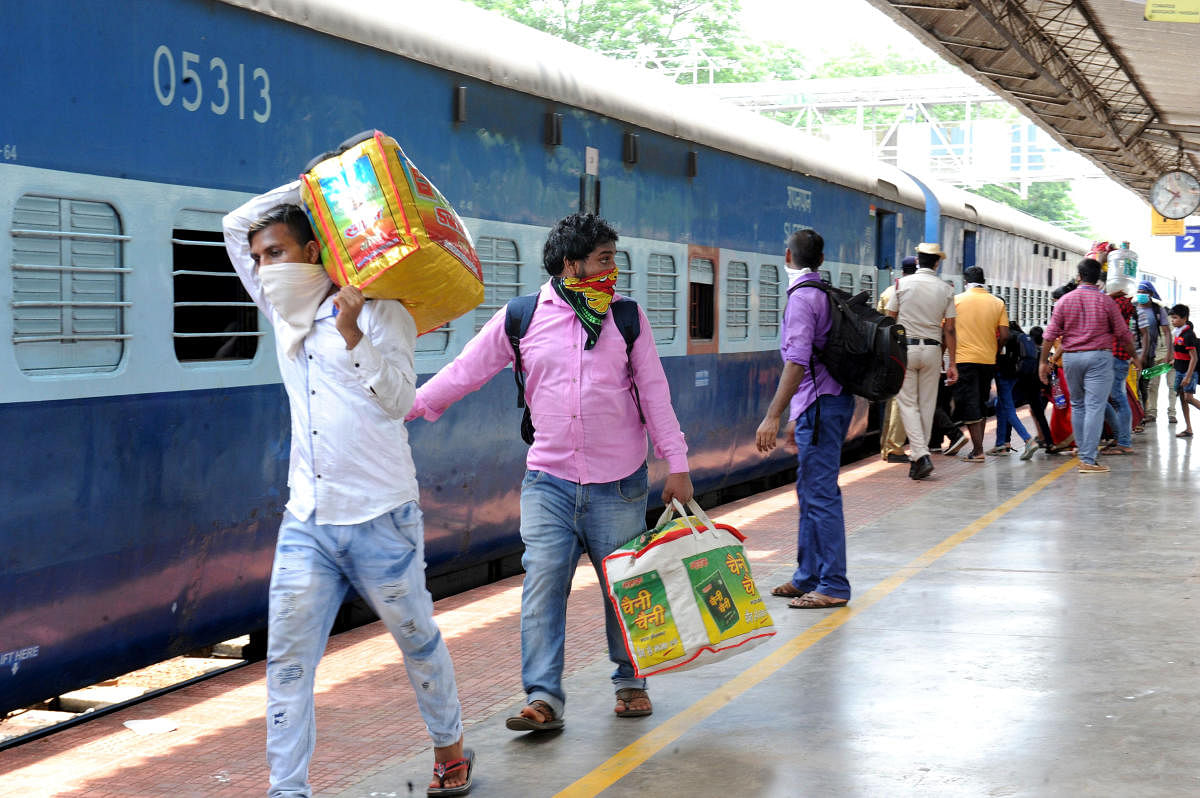 Labourers travelling to Uttar Pradesh and Bihar in a special train from Mangalore Junction Railway Station on Sunday. DH Photo/Govindraj Javali