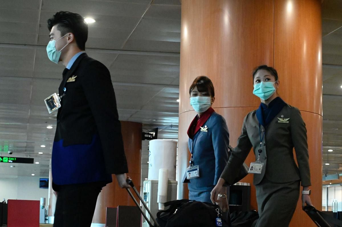Flights attendants wear protective face masks at the Yangon airport. AFP file photo