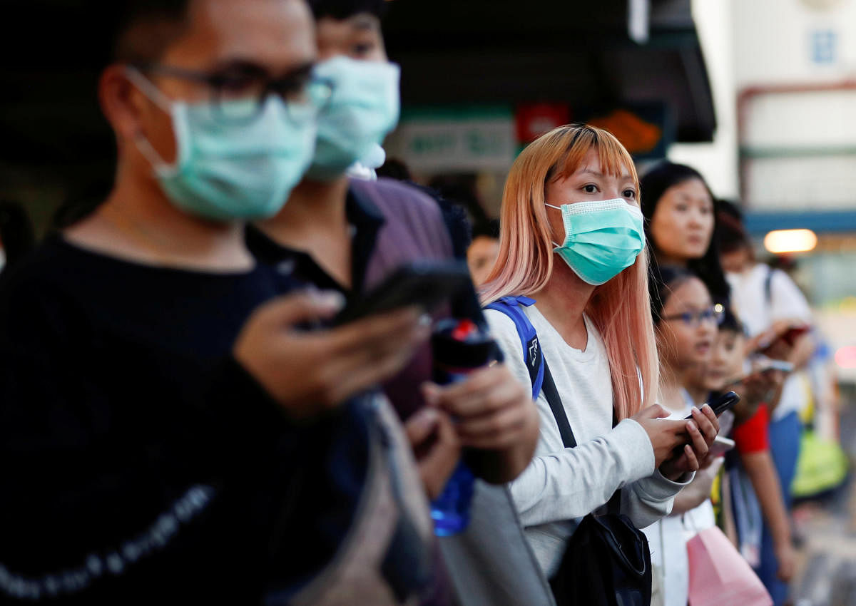 Commuters wait for a transport to leave the Woodlands Causeway across to Singapore from Johor, hours before Malaysia imposes a lockdown on travel due to the coronavirus outbreak. Credit: Reuters File Photo
