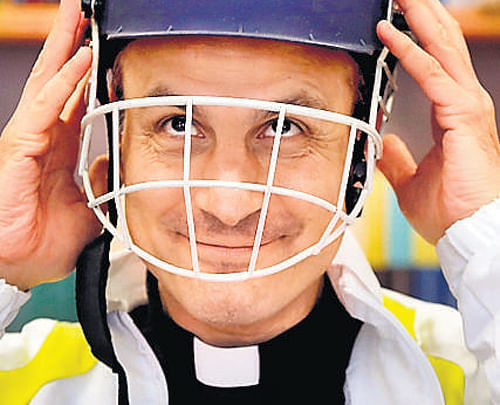 Monsignor Sanchez de Toca y Alameda, undersecretary of the Pontifical Council for Culture, wears a cricket helmet at the Vatican on Tuesday. AP