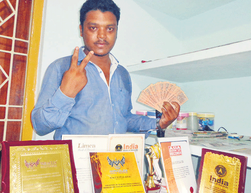 Raj Kishore Mahanta with his awards and Sachin Tendulkar notes collection.
