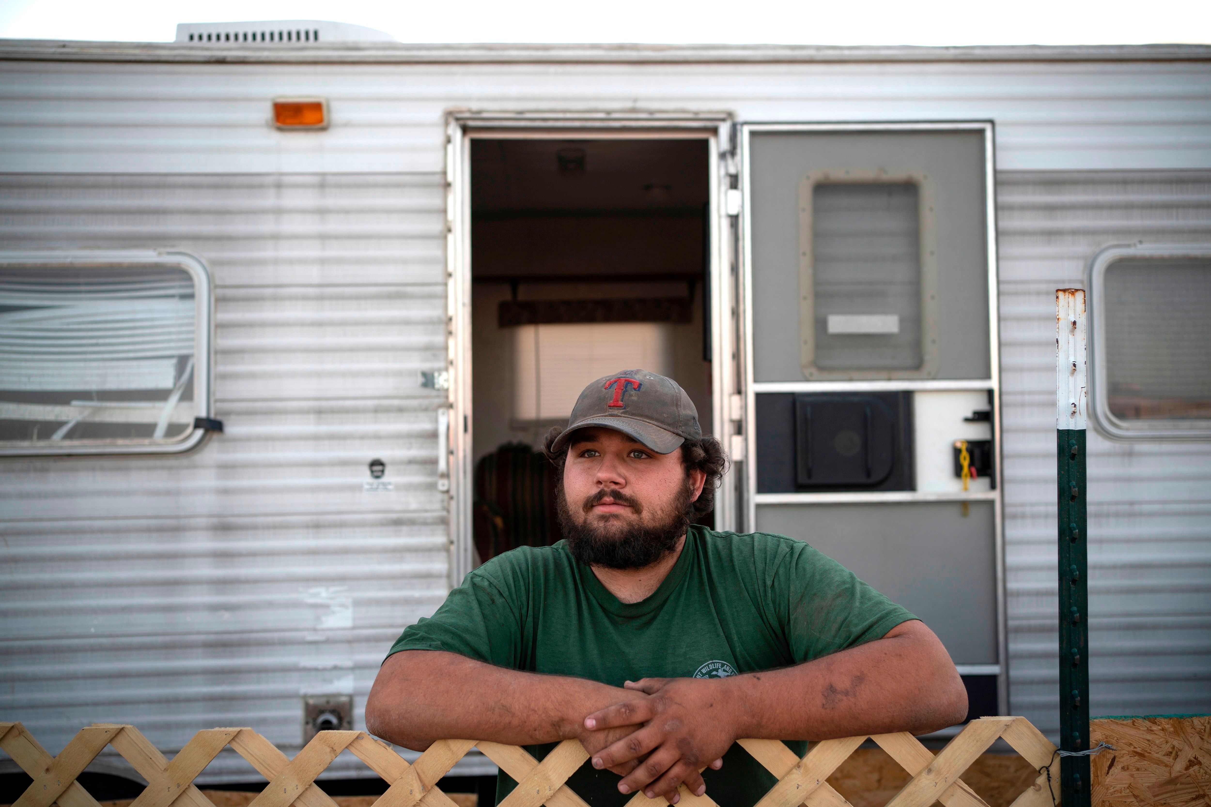 Tyler Dean, 21, from Toro Louisiana poses for a portrait in front of his trailer on May 6, 2020 in Carlsbad, New Mexico. - Dean was working as a plumber and has kept his job, despite many workers having lost theirs as oil prices have gone on a rollercoaster due to a sharp decline in demand and a price war between Saudi Arabia and Russia. (AFP photo)