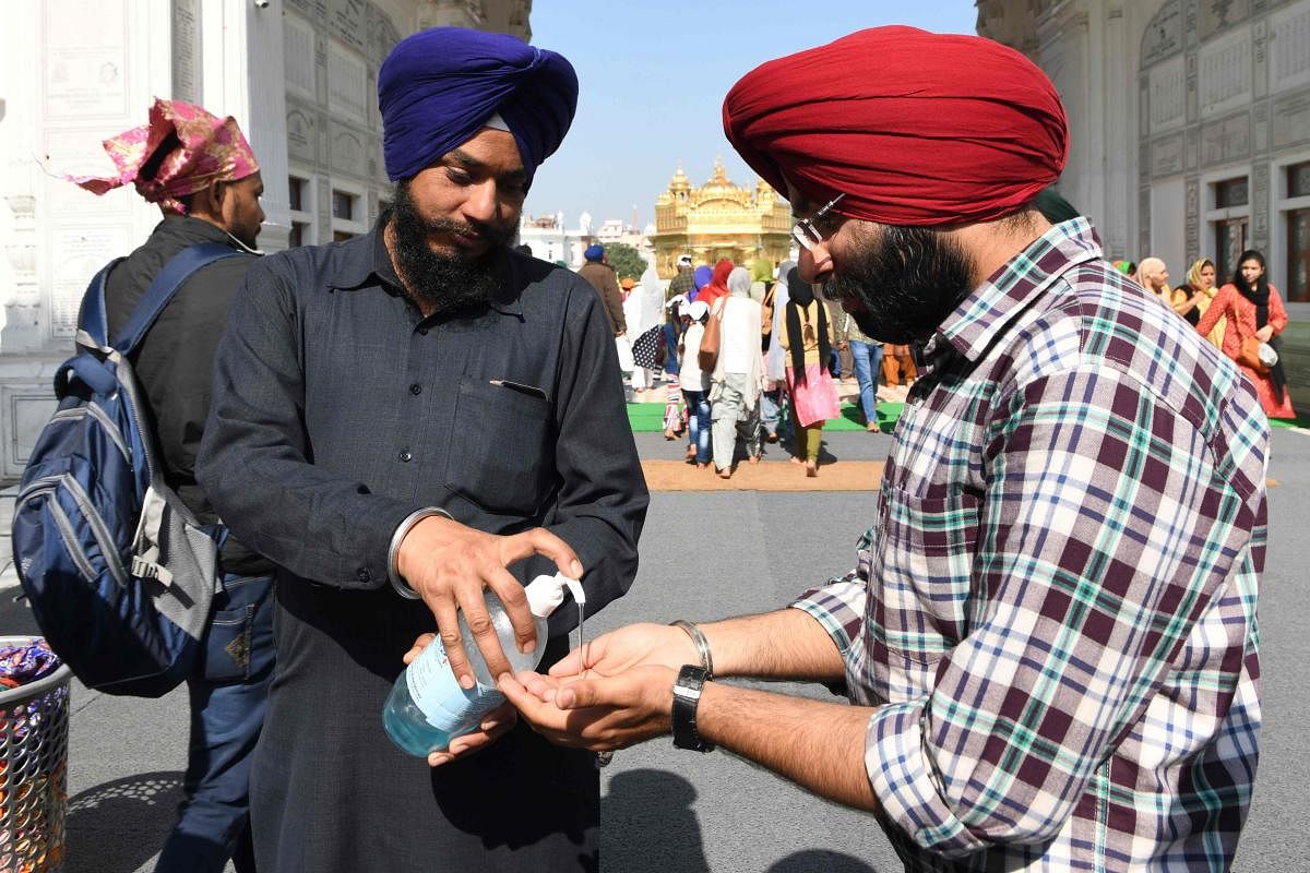 Sikh devotee use hand sanitiser amid concerns over the spread of the COVID-19 coronavirus (AFP Photo)