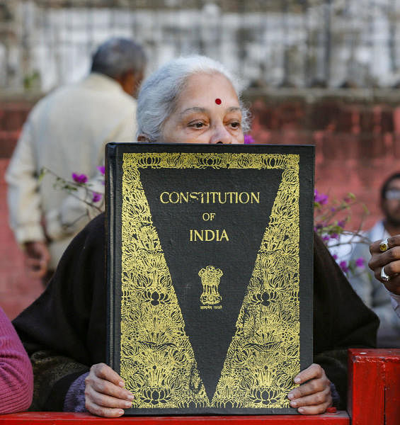 An aged-woman holds a copy of the Indian constitution during a protest against Citizenship (Amendment) Act, outside Gandhi ashram in Ahmedabad, Monday, Jan. 20, 2020. (PTI Photo)