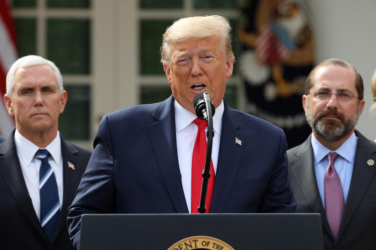U.S. President Donald Trump declares the coronavirus pandemic a national emergency as Vice President Mike Pence and Health and Human Services Secretary Alex Azar listen during a news conference in the Rose Garden of the White House in Washington, U.S., March 13, 2020. (REUTERS Photo)