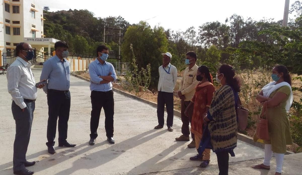 ZP CEO H V Darshan and AC C Somashekhar inspect quarantine centre at Mangasandra in Kolar taluk on Monday.