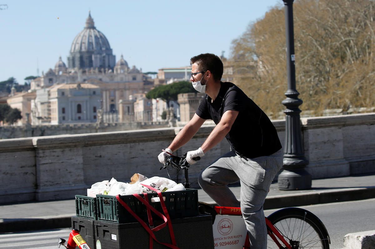 A delivery person passes near St. Peter's Basilica, as Italy tightens measures to try and contain the spread of coronavirus disease (COVID-19), in Rome. Credit: Reuters Photo