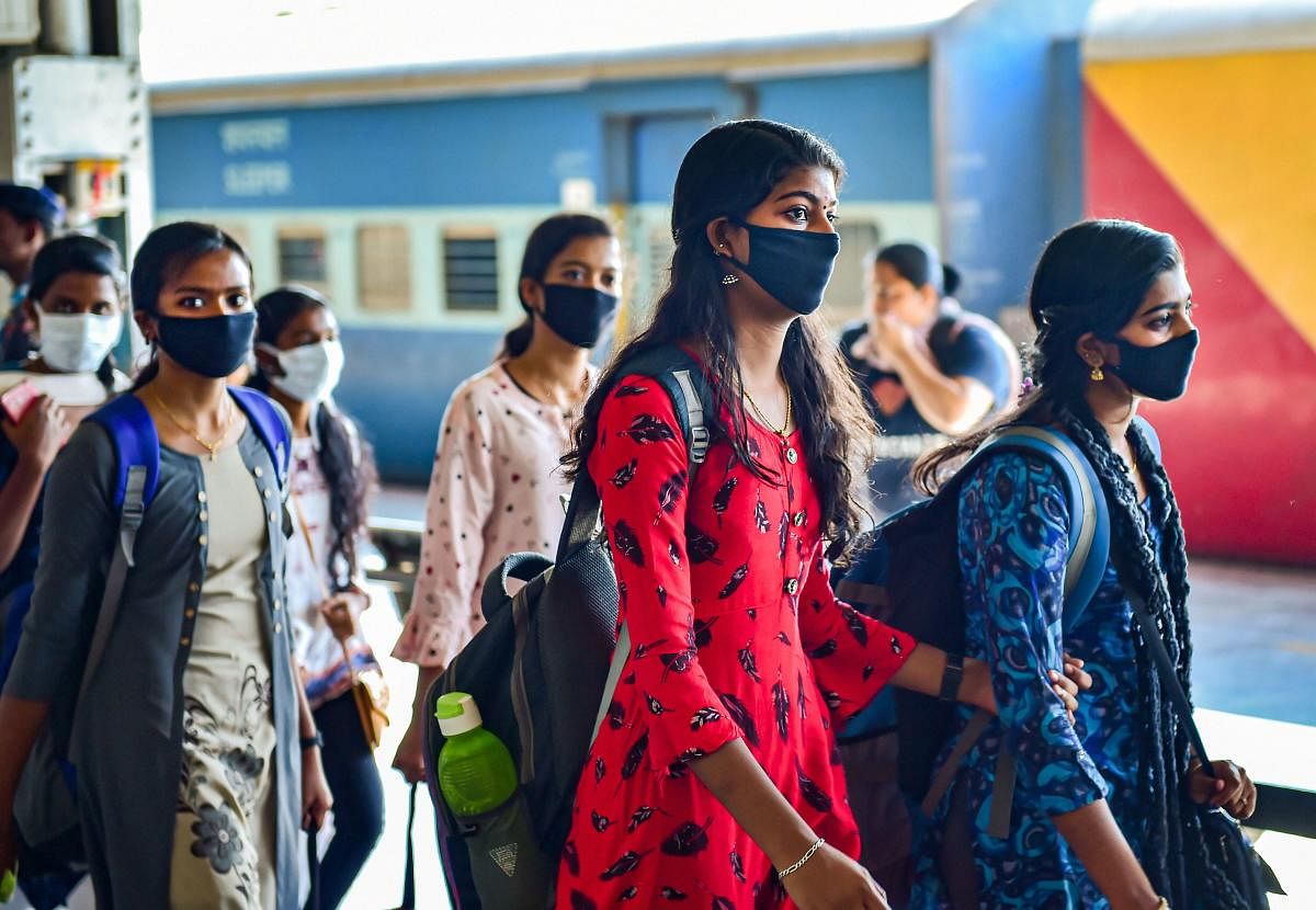 Passengers wearing masks in wake of coronavirus (COVID-19) pandemic walk inside Bengaluru City Railway Station, Monday, March 16, 2020. (PTI Photo)