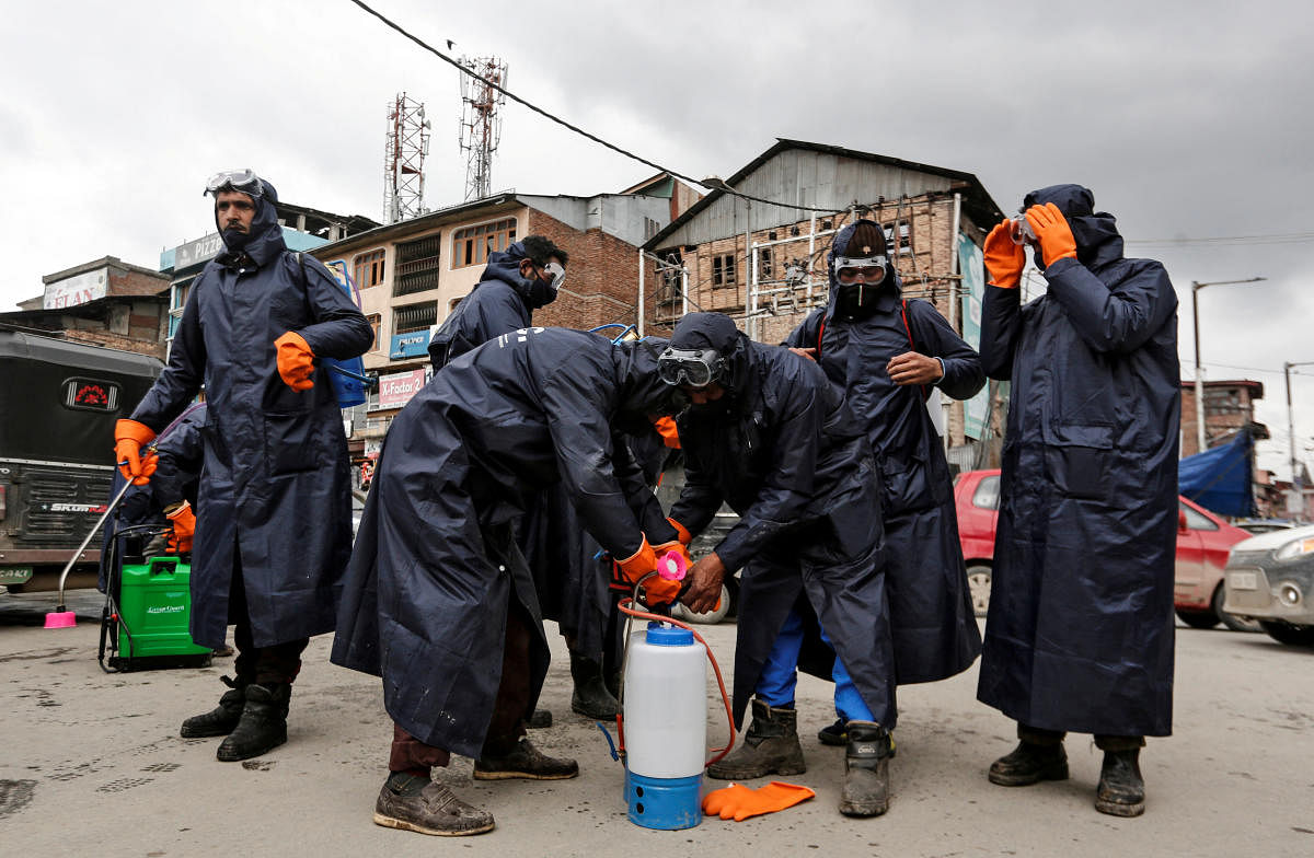Municipal workers prepare to disinfect a mosque, amid coronavirus fears in Srinagar. Reuters