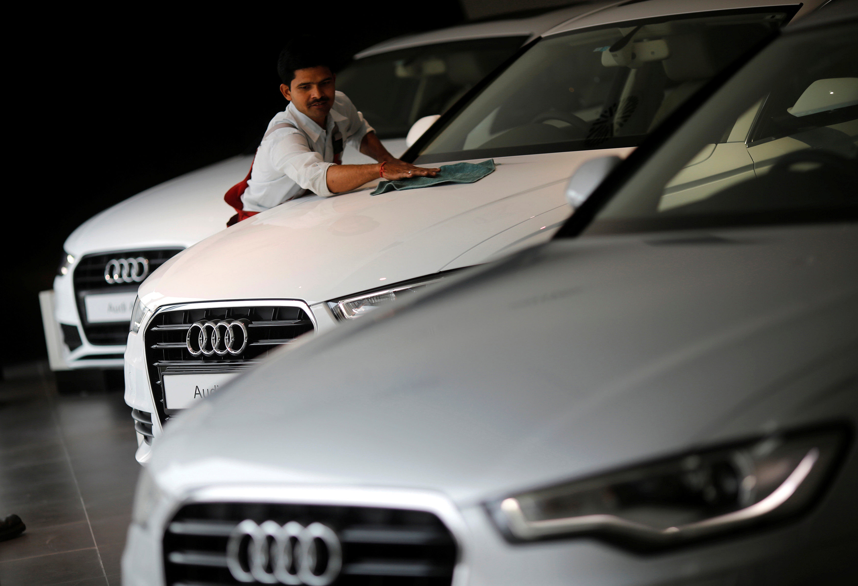 A worker cleans an Audi car on display at Audi's showroom in New Delhi. (Reuters file photo)