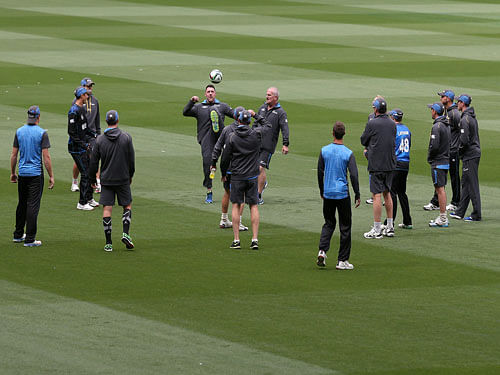New Zealand's team and assistants kick a soccer ball as they warm up for training for the Cricket World Cup final at the Melbourne Cricket Ground in Melbourne, Australia, Friday, March 27, 2015. New Zealand will play Australia in the final Sunday. AP Photo.