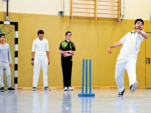 game on Afghan refugees take part in a cricket training session at the Altendorf 09 Blue Tigers club in Essen. AFP
