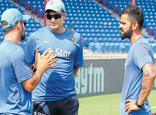 STRATEGIC BREAK: India limited-overs captain MS Dhoni (left) and coach Anil Kumble discuss a point as Virat Kohli looks on on the eve of their Saturday's first T20I against West Indies. BCCI