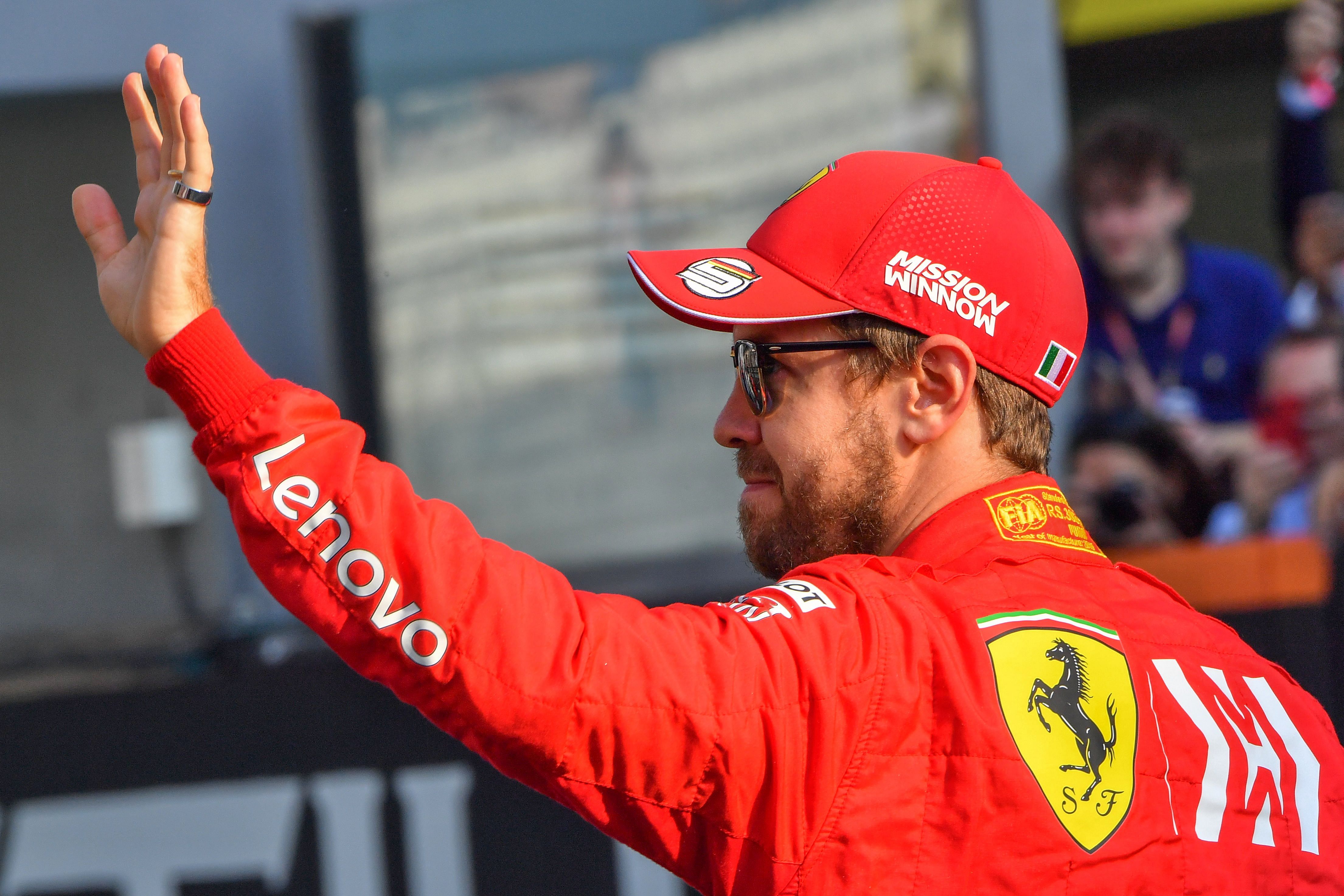 In this file photo taken on December 1, 2019 Ferrari's German driver Sebastian Vettel waves at the Yas Marina Circuit in Abu Dhabi. (Credit: AFP Photo)