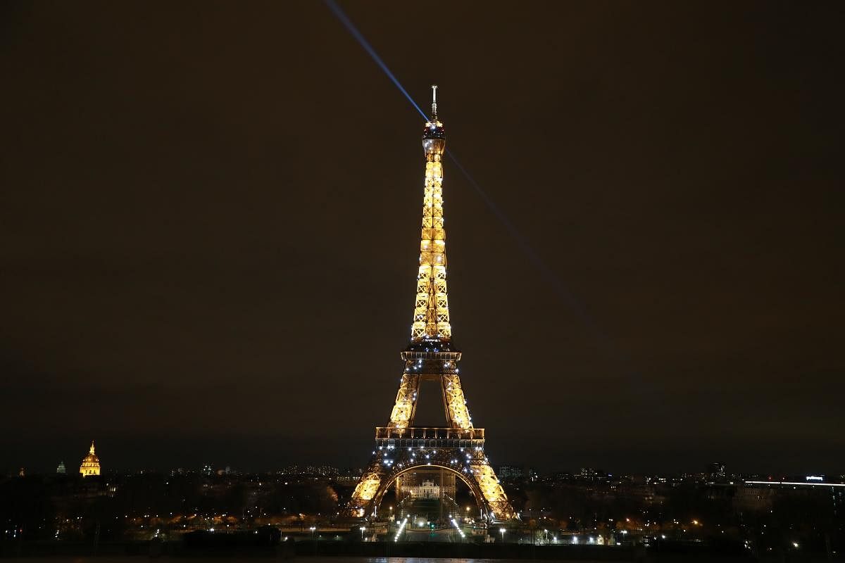 A picture taken in Paris on March on 17, 2020, shows the Eiffel Tower shining brightly every evening at 8 p.m. since March 20, 2020 to support hospital staff and other people involved in the fight against coronavirus. (AFP Photo)