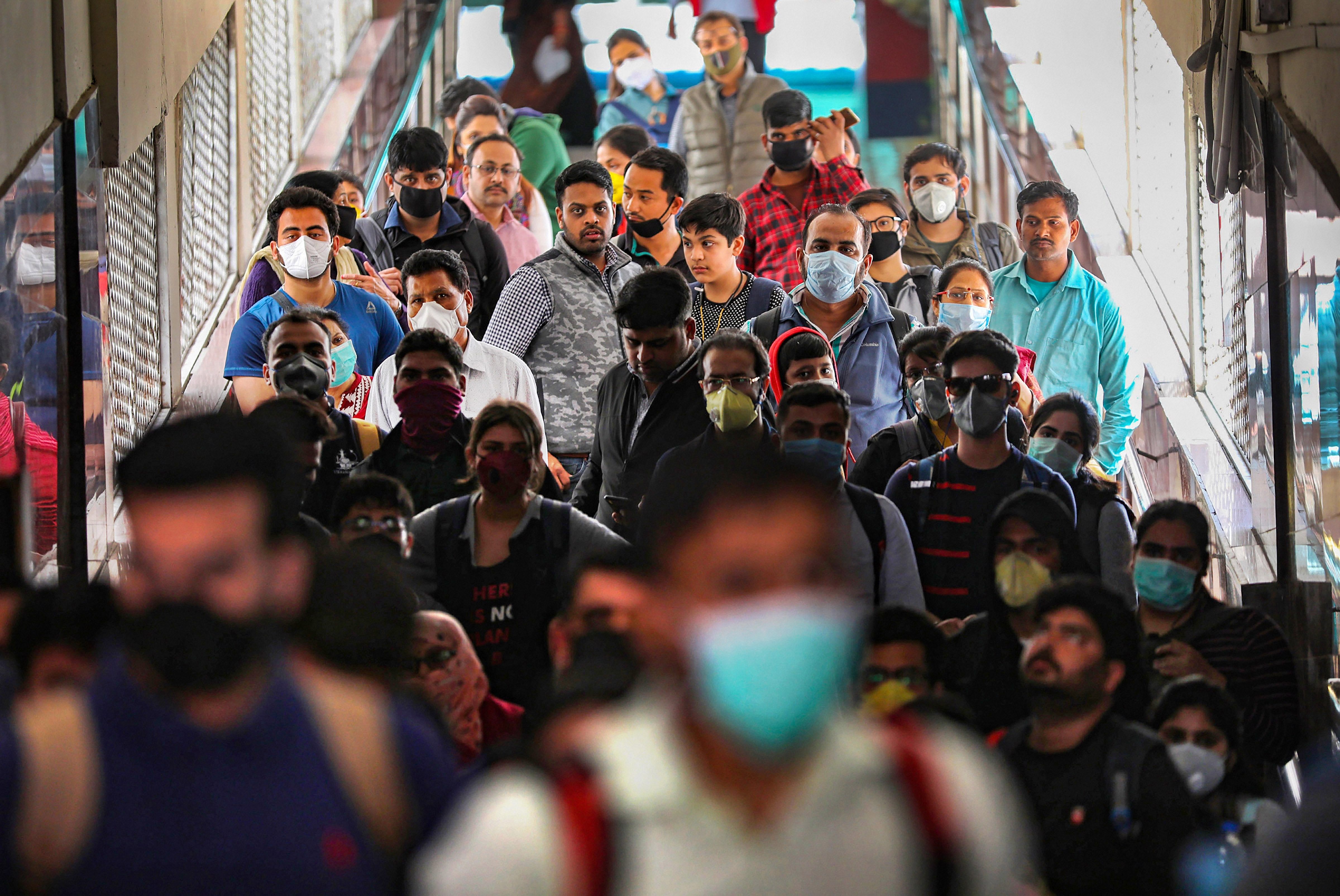 Passengers wear masks a precautionary measure against the coronavirus pandemic, at a railway station, in Jammu. (PTI Photo)