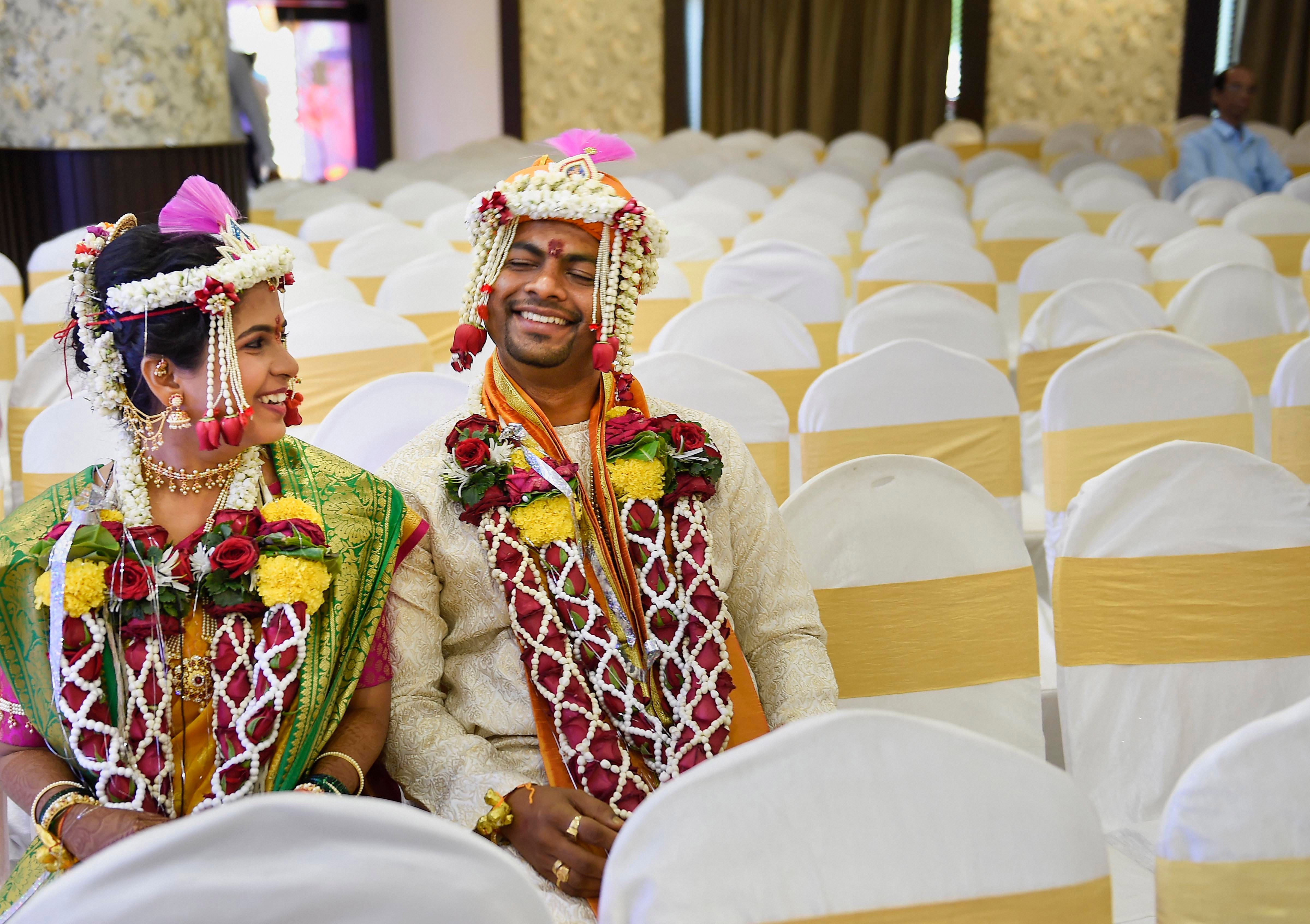 Ruchit Sane (groom) and Akshita Vaidya (bride) share a light moment during their wedding ceremony in Mumbai. (Credit: PTI Photo)