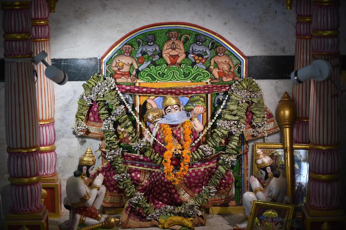  A Lord Hanuman idol with a facemask is seen at a at a Hanuman Temple in Ahmedabad on March 17, 2020. Credit: AFP Photo