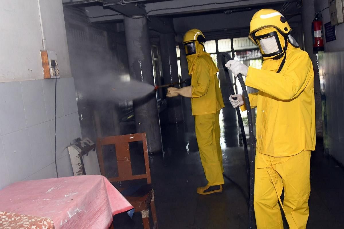  Workers spray disinfectant inside a civil hospital campus to contain the spread of coronavirus, in Surat (PTI Photo)