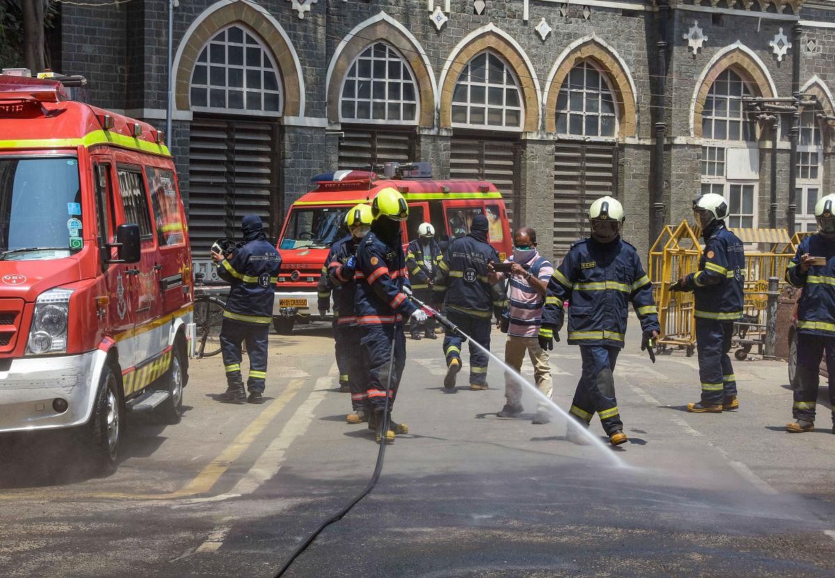Fire brigade personnel spray disinfectants outside BMC headquater amid concerns over the spread of the COVID-19 disease (PTI Photo)