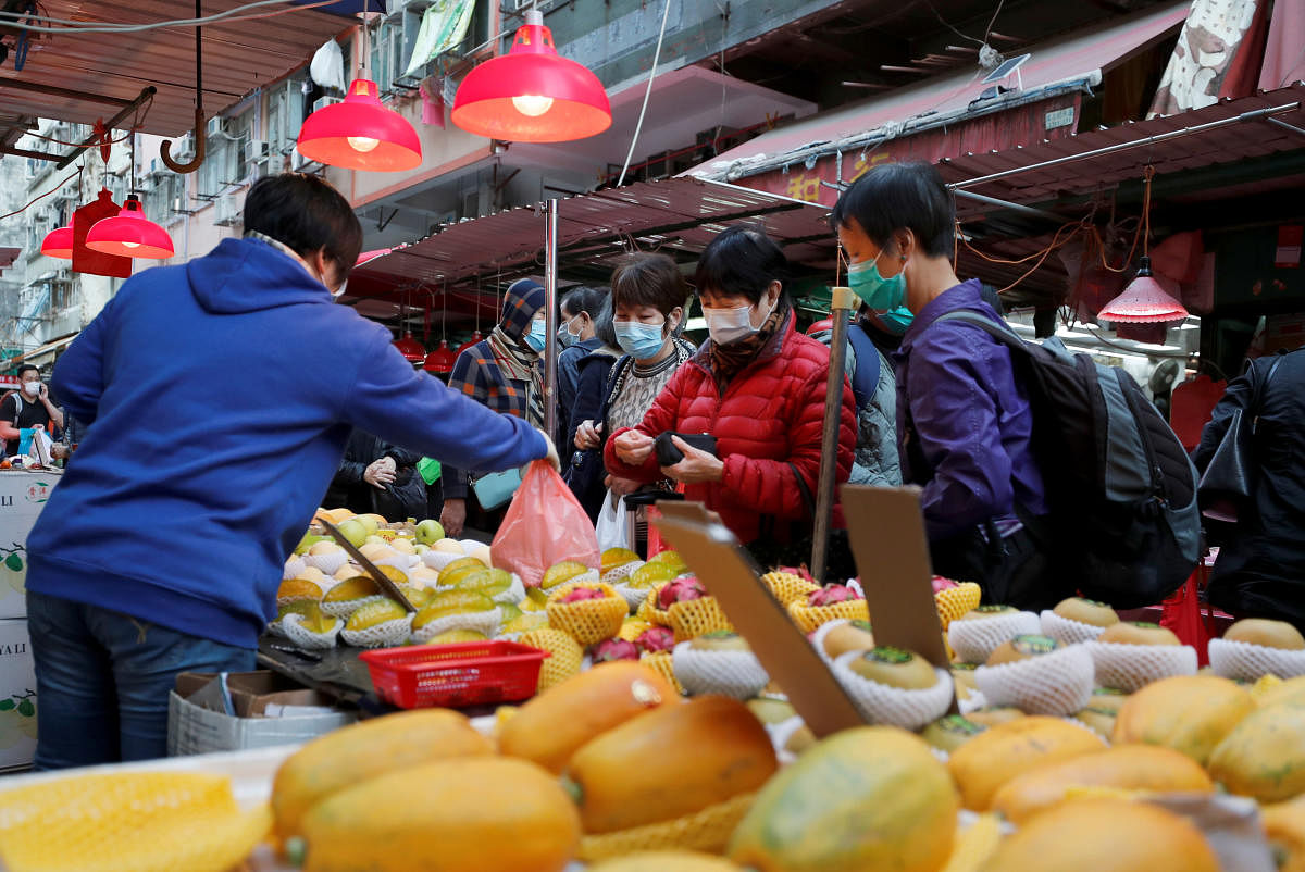 eople wear protective masks as they shop at a market following the outbreak of the new coronavirus, in Hong Kong, China. (Reuters Image)