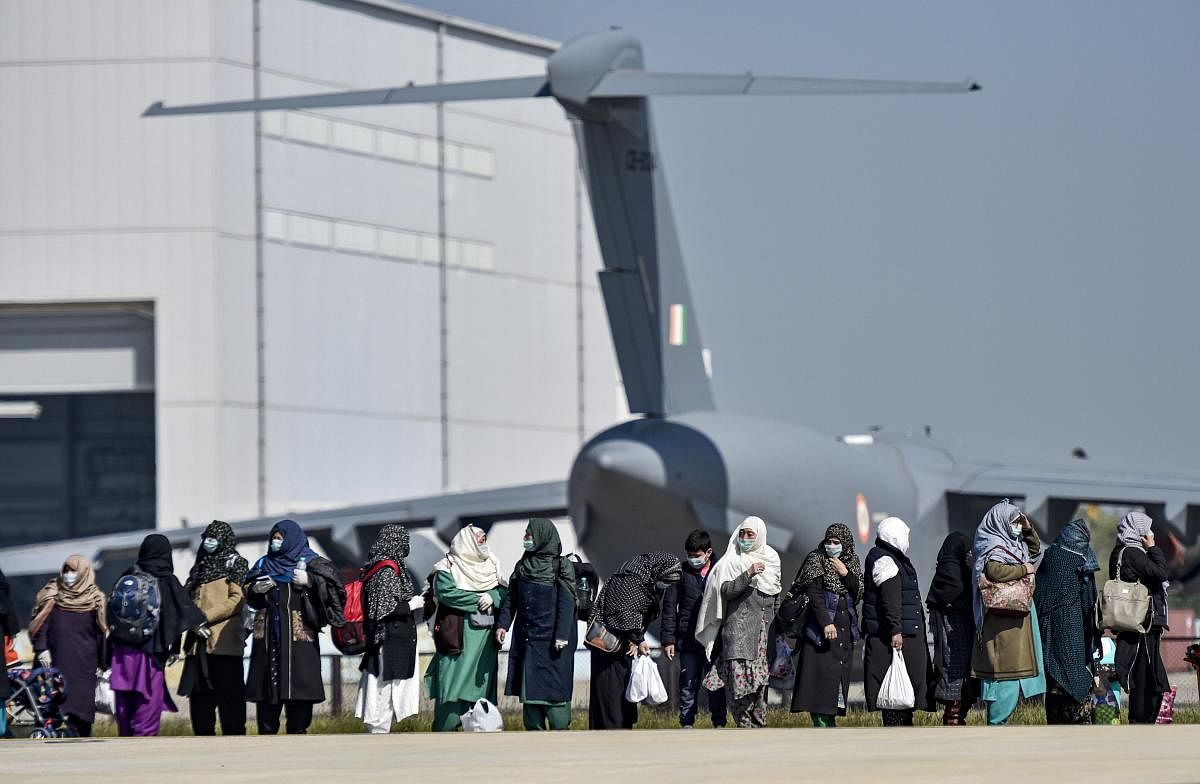 Indian nationals after they were brought to India by Indian Air Force's (IAF) C-17 Globemaster III aircraft from coronavirus-hit Iran at Hindan airport, Tuesday, March 10, 2020. Fifty-eight Indians were airlifted in the military transport aircraft. (PTI Photo)