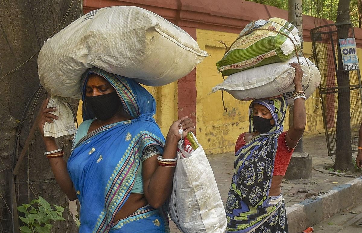 Kolkata: Migrants carry their belongings as they walk along a road towards their native places in Odisha during the ongoing nationwide COVID-19 lockdown, in Kolkata, Monday, May 11, 2020. (PTI Photo/Ashok Bhaumik)(PTI11-05-2020_000154B)