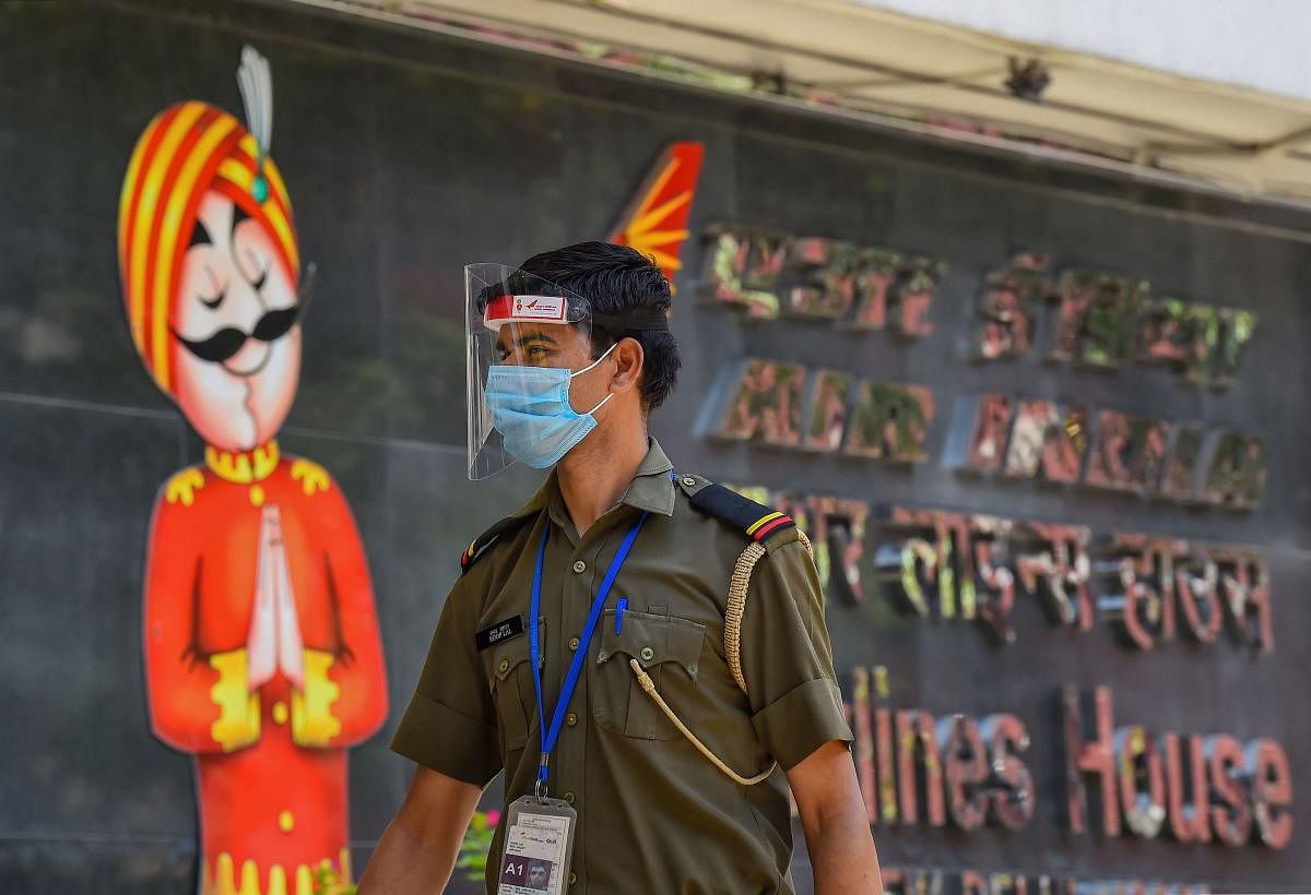 A security personnel stands outside the sealed Air India's Delhi office after reports of a staffer being COVID-19 positive, during the ongoing nationwide lockdown to curb the spread of coronavirus, in New Delhi, Tuesday, May 12, 2020. Credit: PTI Photo