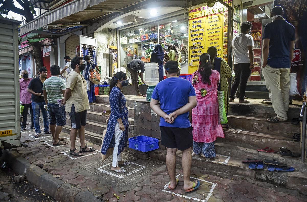 People maintain social distance as they wait outside a grocery shop during a 21-day nationwide lockdown in the wake of coronavirus pandemic (PTI Photo)