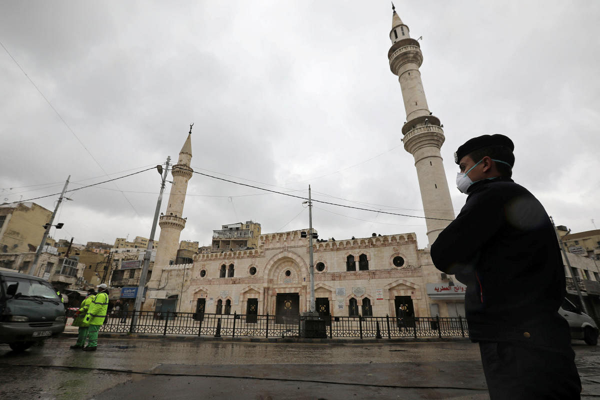 A Jordanian policeman stands guard in front of al Husseini mosque building after closing it to the worshipers amid concerns over the coronavirus disease (COVID-19) spread, in downtown Amman. Reuters
