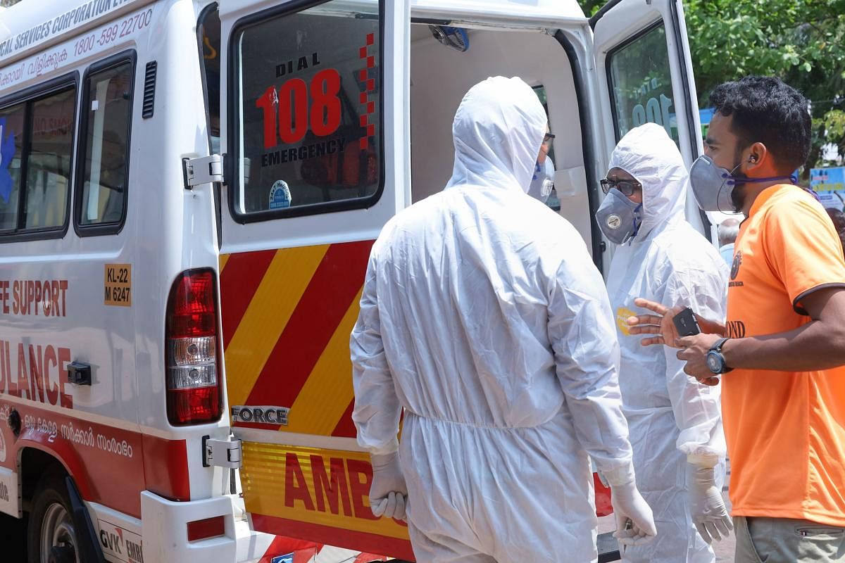  Medic officials wear protective suits as they arrive to take a coronavirus suspected passenger, at a railway station in Kozhikode, Saturday, March 21, 2020. (PTI Photo)