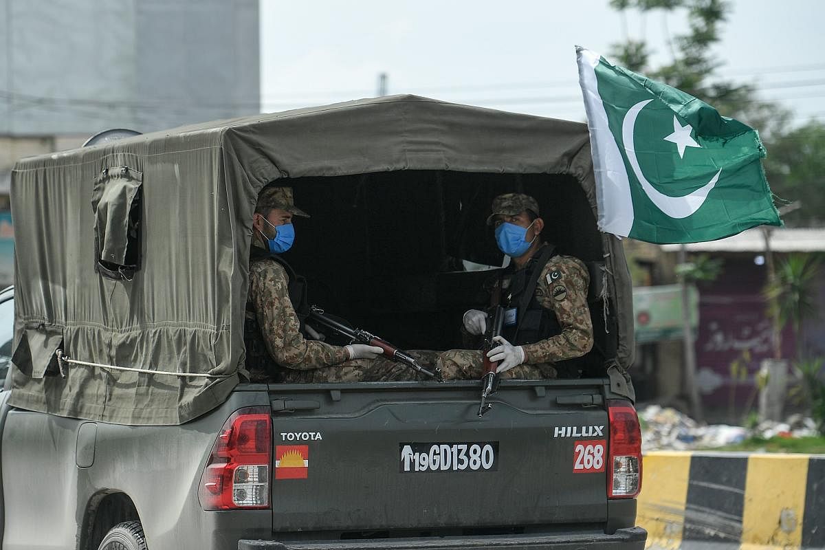 Security personnel wearing facemasks patrol in Bhara Kahu area during the first day of a 21-day government-imposed nationwide lockdown as a preventive measure against the COVID-19 coronavirus, in Islamabad (Photo AFP)