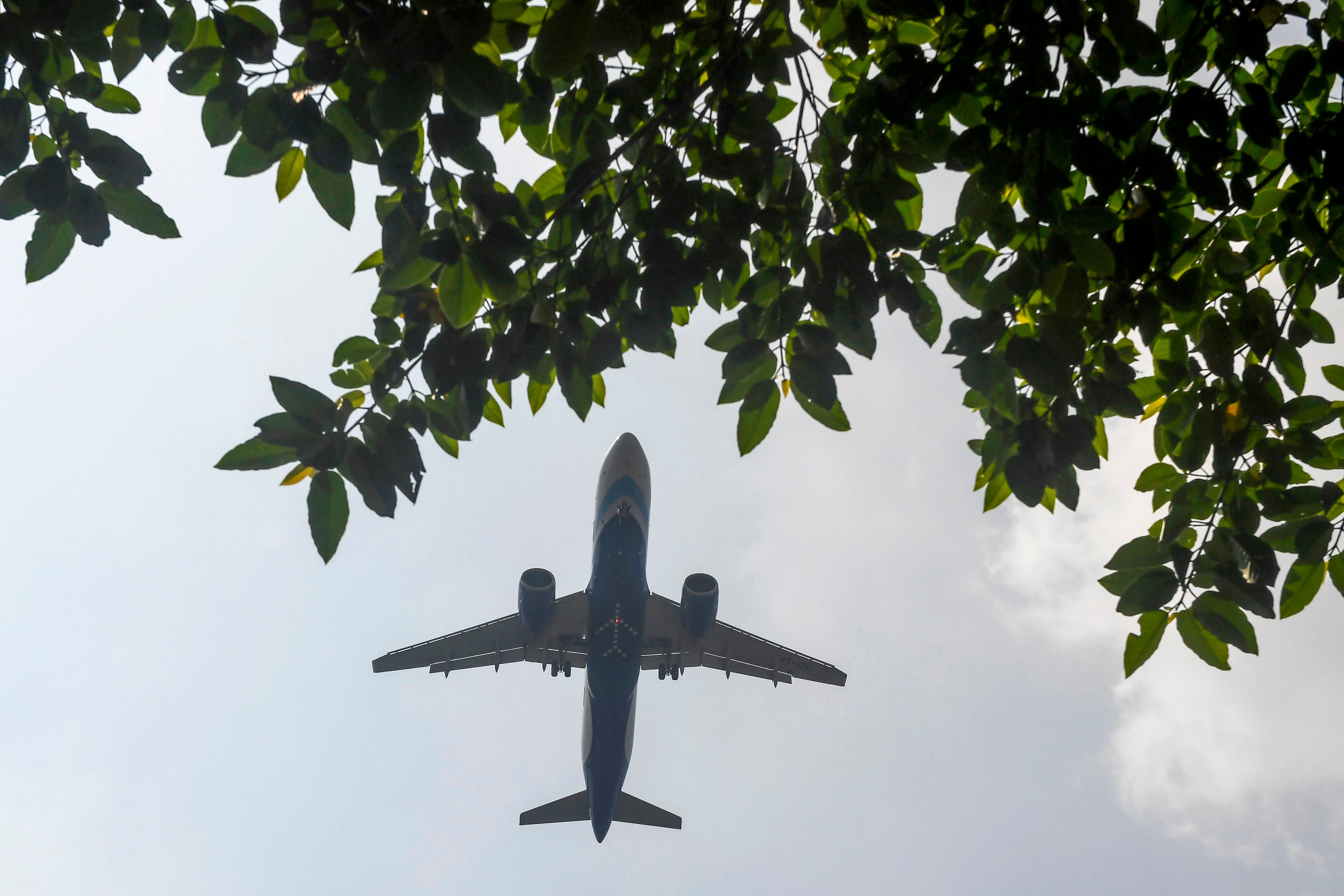 A commercial passenger plane prepares to land at Netaji Subhash Chandra Bose International Airport, in Kolkata. (Credit: AFP)